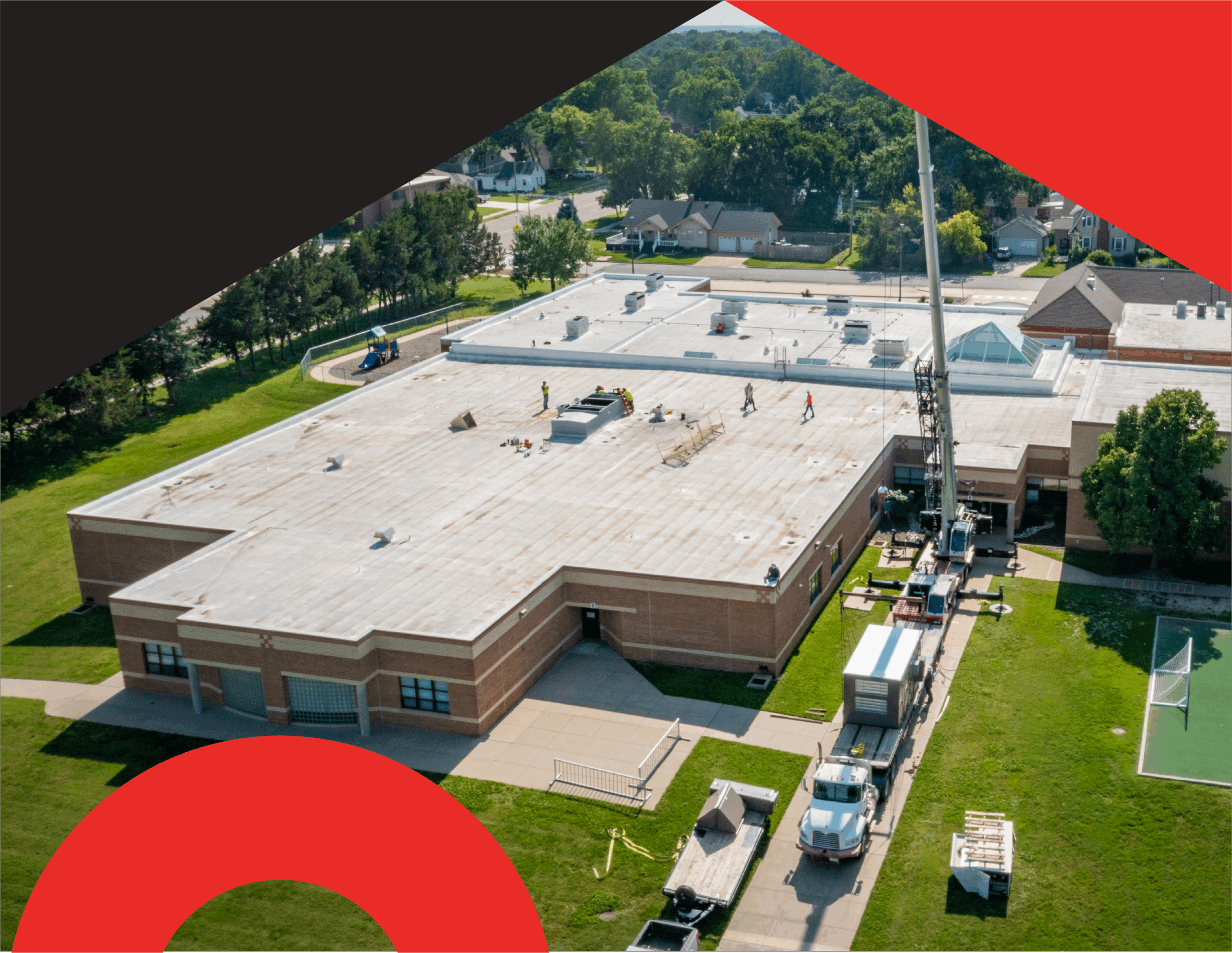 Aerial view of school HVAC upgrades funded through bond measure support, showing installation work that improves total cost of ownership.